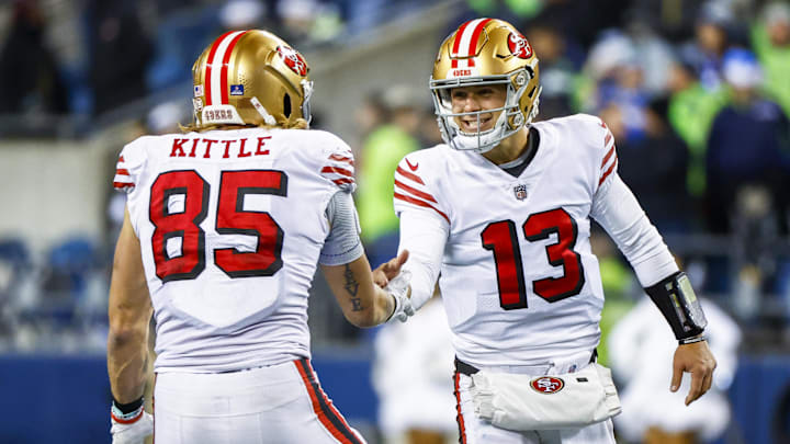 San Francisco 49ers quarterback Brock Purdy (13) celebrates with tight end George Kittle (85)