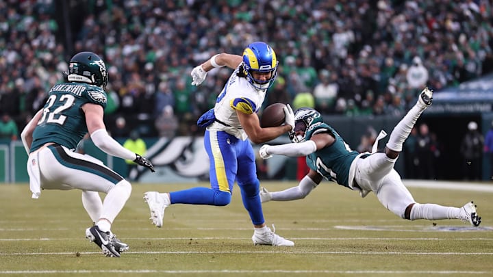 Jan 19, 2025; Philadelphia, Pennsylvania, USA; Los Angeles Rams wide receiver Puka Nacua (17) intercepts a pass in front of Philadelphia Eagles safety Reed Blankenship (32) and Eagles cornerback Quinyon Mitchell (27) during the first half in a 2025 NFC divisional round game at Lincoln Financial Field. Mandatory Credit: Bill Streicher-Imagn Images