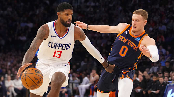 Nov 6, 2023; New York, New York, USA; Los Angeles Clipper forward Paul George (13) dribbles the ball against New York Knicks shooting guard Donte DiVincenzo (0) during the fourth quarter at Madison Square Garden. Mandatory Credit: Gregory Fisher-USA TODAY Sports