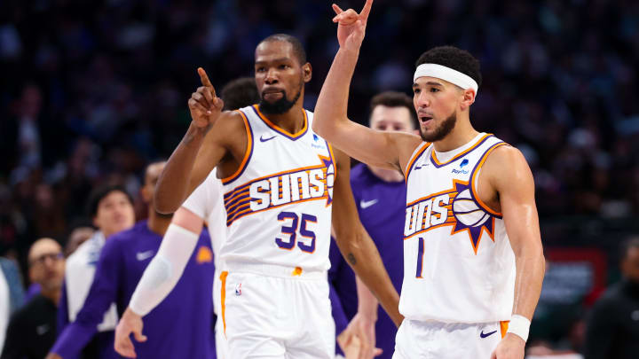 Jan 24, 2024; Dallas, Texas, USA;  Phoenix Suns guard Devin Booker (1) celebrates with Phoenix Suns forward Kevin Durant (35) during the third quarter against the Dallas Mavericks at American Airlines Center. Mandatory Credit: Kevin Jairaj-USA TODAY Sports