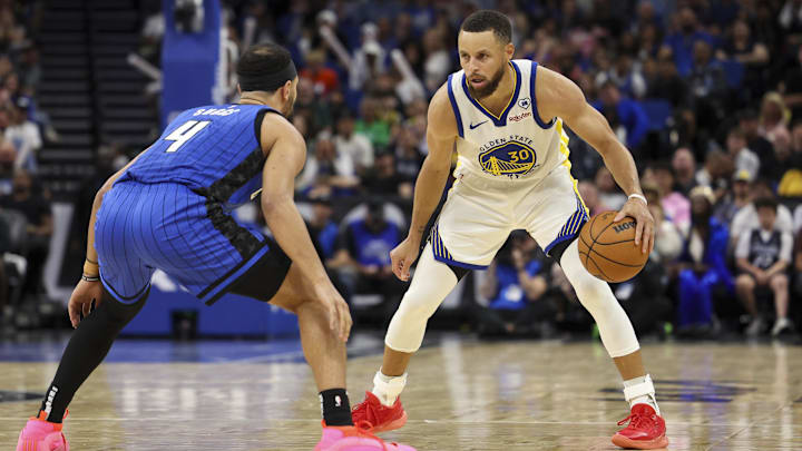 Orlando Magic guard Jalen Suggs (4) guards Golden State Warriors guard Stephen Curry (30) in the fourth quarter at the Kia Center. Orlando Magic guard Jalen Suggs (4) guards Golden State Warriors guard Stephen Curry (30) in the fourth quarter at the Kia Center.