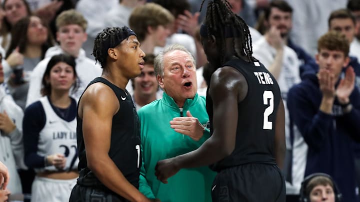 Dec 13, 2025; University Park, Pennsylvania, USA; Michigan State Spartans head coach Tom Izzo talks with guard Jeremy Fears Jr (1) and guard Kur Teng (2) during the second half against the Penn State Nittany Lions at Bryce Jordan Center. Mandatory Credit: Matthew O'Haren-Imagn Images Dec 13, 2025; University Park, Pennsylvania, USA; Michigan State Spartans head coach Tom Izzo talks with guard Jeremy Fears Jr (1) and guard Kur Teng (2) during the second half against the Penn State Nittany Lions at Bryce Jordan Center. Mandatory Credit: Matthew O'Haren-Imagn Images