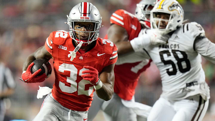 Sep 7, 2024; Columbus, Ohio, USA; Ohio State Buckeyes running back TreVeyon Henderson (32) runs for a touchdown past Western Michigan Broncos defensive lineman Tyson Lee (58) during the second half of the NCAA football game at Ohio Stadium. Sep 7, 2024; Columbus, Ohio, USA; Ohio State Buckeyes running back TreVeyon Henderson (32) runs for a touchdown past Western Michigan Broncos defensive lineman Tyson Lee (58) during the second half of the NCAA football game at Ohio Stadium.