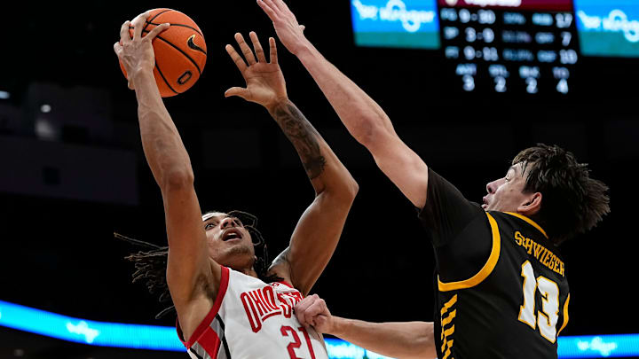 Ohio State Buckeyes forward Devin Royal (21) shoots over Valparaiso Beacons forward Cooper Schwieger (13) during the second half of the NCAA men's basketball game at Value City Arena in Columbus on Dec. 17, 2024. Ohio State won 95-73.