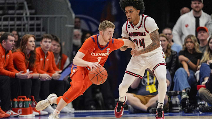 Mar 14, 2025; Charlotte, NC, USA; Clemson Tigers guard Jake Heidbreder (3) handles the ball against Louisville Cardinals guard Chucky Hepburn (24) during the second half at Spectrum Center. 