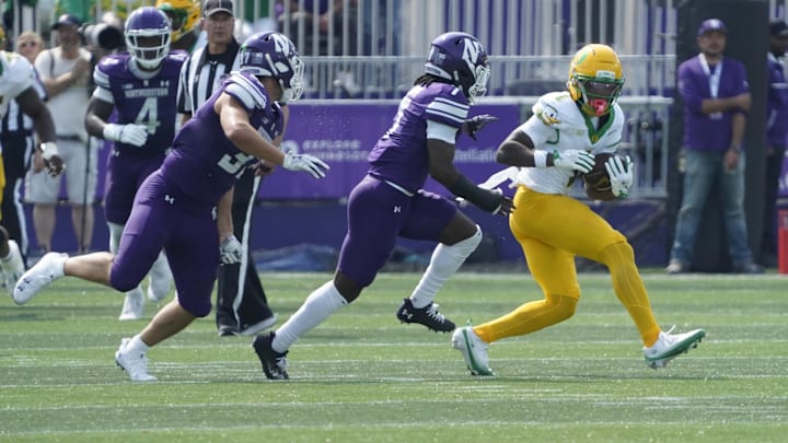 Sep 13, 2025; Evanston, Illinois, USA; Oregon Ducks wide receiver Dakorien Moore (1) catches a pass against the Northwestern Wildcats during the first half at Northwestern Medicine Field at Martin Stadium. Mandatory Credit: David Banks-Imagn Images