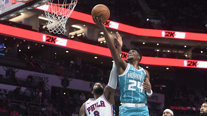 Dec 16, 2024; Charlotte, North Carolina, USA;  Charlotte Hornets forward Brandon Miller (24) drives past Philadelphia 76ers forward Paul George (8) during the second half at the Spectrum Center. Mandatory Credit: Sam Sharpe-Imagn Images