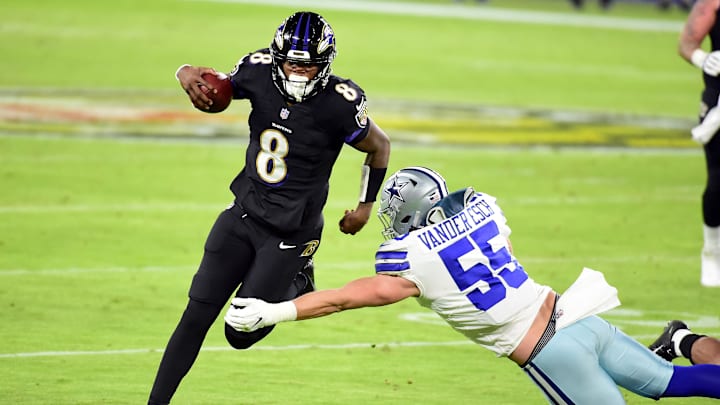 Dec 8, 2020; Baltimore, Maryland, USA; Baltimore Ravens quarterback Lamar Jackson (8) avoids the tackle of Dallas Cowboys linebacker Leighton Vander Esch (55) in the third quarter at M&T Bank Stadium. Mandatory Credit: Evan Habeeb-USA TODAY Sports