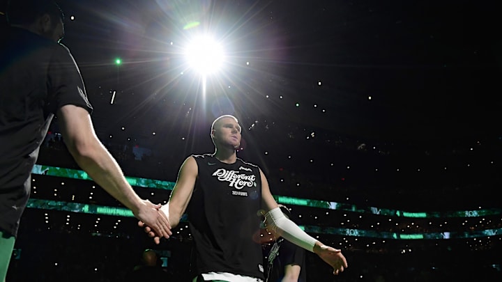 Apr 20, 2025; Boston, Massachusetts, USA; Boston Celtics center Kristaps Porzingis (8) is introduced prior to a game against the Orlando Magic at TD Garden. Mandatory Credit: Bob DeChiara-Imagn Images