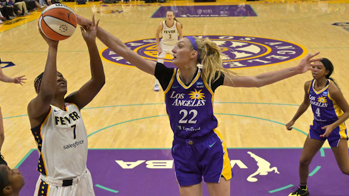 May 24, 2024; Los Angeles, California, USA;  Los Angeles Sparks forward Cameron Brink (22) blocks a shot by Indiana Fever forward Aliyah Boston (7)