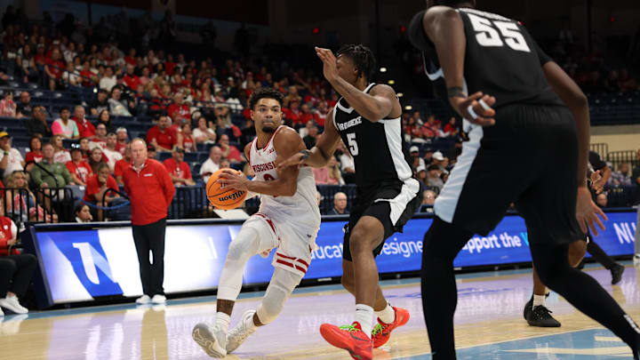 Nov 27, 2025; San Diego, CA, USA; Wisconsin Badgers guard Nick Boyd (2) handles the ball against Providence Friars forward Jamier Jones (5) during the second half at Jenny Craig Pavilion. 
