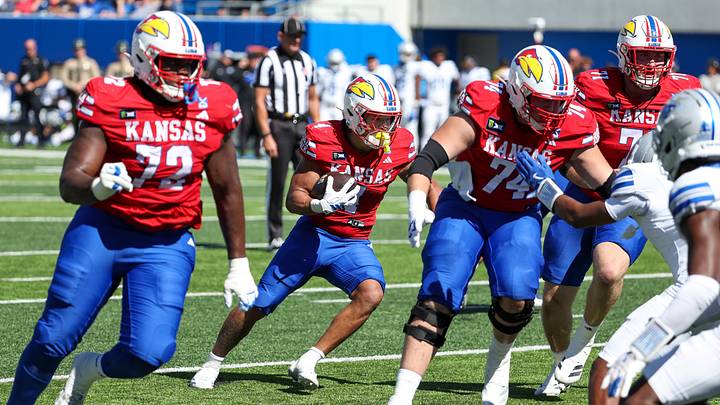 Oct 3, 2026; Lawrence, Kansas, USA; Kansas Jayhawks running back Jalen Dupree (4) follows blockers during the fourth quarter against the Middle Tennessee Blue Raiders at David Booth Kansas Memorial Stadium. Mandatory Credit: Scott Sewell-Imagn Images Oct 3, 2026; Lawrence, Kansas, USA; Kansas Jayhawks running back Jalen Dupree (4) follows blockers during the fourth quarter against the Middle Tennessee Blue Raiders at David Booth Kansas Memorial Stadium. Mandatory Credit: Scott Sewell-Imagn Images