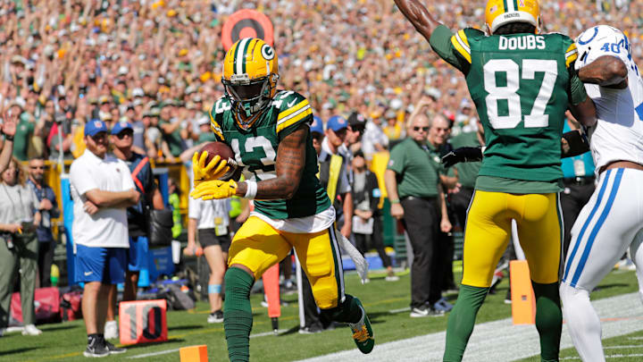 Green Bay Packers wide receiver Dontayvion Wicks (13) scores a touchdown against the Indianapolis Colts. He is questionable for Sunday against the Texans.