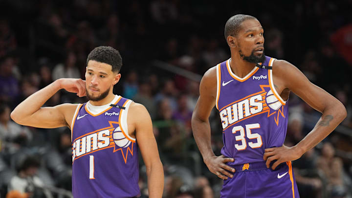 Nov 27, 2024; Phoenix, Arizona, USA; Phoenix Suns guard Devin Booker (1) and Phoenix Suns forward Kevin Durant (35) look on against the Brooklyn Nets during the second half at Footprint Center. Mandatory Credit: Joe Camporeale-Imagn Images