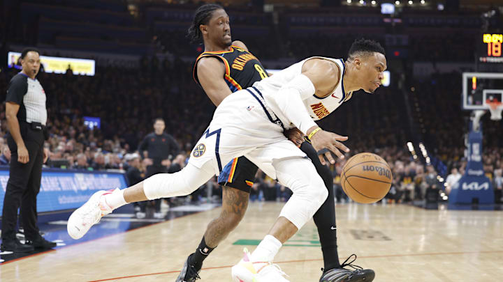 May 5, 2025; Oklahoma City, Oklahoma, USA; Denver Nuggets guard Russell Westbrook (4) drives against Oklahoma City Thunder forward Jalen Williams (8) during the second quarter during game one of the second round for the 2025 NBA Playoffs at Paycom Center. Mandatory Credit: Alonzo Adams-Imagn Images