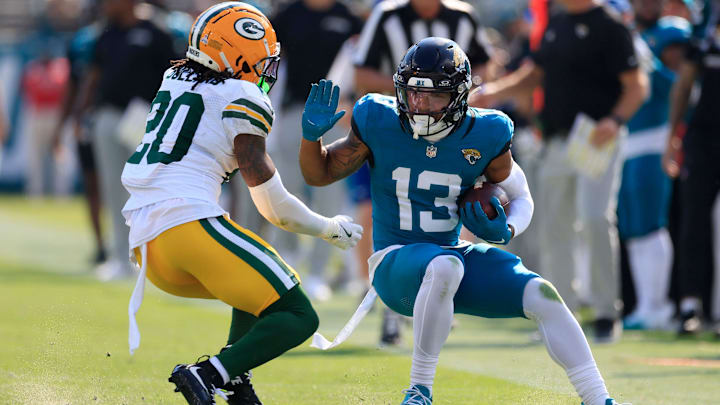 Jacksonville Jaguars wide receiver Christian Kirk (13) tries to manuver past Green Bay Packers safety Javon Bullard (20) during the third quarter of an NFL football matchup Sunday, Oct. 27, 2024 at EverBank Stadium in Jacksonville, Fla. The Packers edged the Jaguars 30-27 on a last-second field goal.