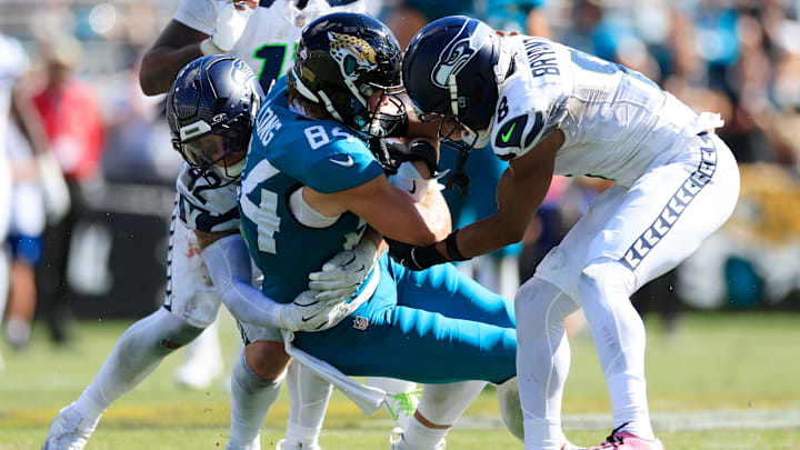 Jacksonville Jaguars tight end Hunter Long (84), center, is tackled by Seattle Seahawks linebacker Drake Thomas (42), left, and safety Coby Bryant (8) during the third quarter of an NFL football matchup, Sunday, Oct. 12, 2025, at EverBank Stadium in Jacksonville, Fla. The Seahawks defeated the Jaguars 20-12. Jacksonville Jaguars tight end Hunter Long (84), center, is tackled by Seattle Seahawks linebacker Drake Thomas (42), left, and safety Coby Bryant (8) during the third quarter of an NFL football matchup, Sunday, Oct. 12, 2025, at EverBank Stadium in Jacksonville, Fla. The Seahawks defeated the Jaguars 20-12.