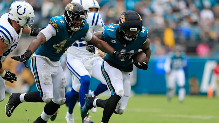 Jacksonville Jaguars defensive end Josh Hines-Allen (41) rushes for yards after picking up a fumble turnover forced by defensive end Travon Walker (44) during the second quarter of an NFL football matchup Sunday, Oct. 6, 2024 at EverBank Stadium in Jacksonville, Fla. The Jaguars edged the Colts on a field goal 37-34. [Corey Perrine/Florida Times-Union]