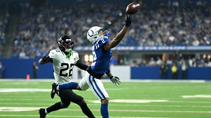 Dec 28, 2025; Indianapolis, Indiana, USA; Indianapolis Colts wide receiver Josh Downs (2) attempts to catch a pass against Jacksonville Jaguars cornerback Jarrian Jones (22) during the first half at Lucas Oil Stadium. Mandatory Credit: Robert Goddin-Imagn Images