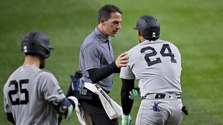 Apr 29, 2026; Arlington, Texas, USA; The New York Yankees team staff check on left fielder Jasson Dominguez (24) after he is hit by pitch during the fourth inning against the Texas Rangers at Globe Life Field. Mandatory Credit: Jerome Miron-Imagn Images