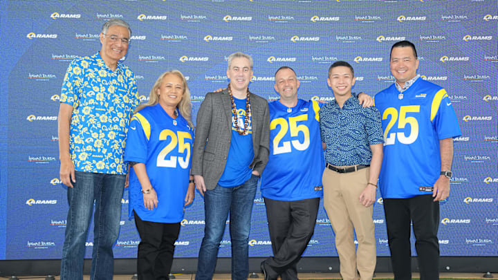 May 7, 2025; Woodland Hills, CA, USA; From left: Hawaii Tourism Authority member Mufi Hannemann, Hawaii state senator and chair of the senate committee on economic development and tourism Lynn DeCoite, Los Angeles Rams president Kevin Demoff, Hawaii governor Josh Green, M.D., Hawaii state representative and chair of the house committee on tourism Adrian Tam and HTA board chair Todd Apo pose during a press conference at the Rams Practice Facility to announce a partnership between the Rams and the