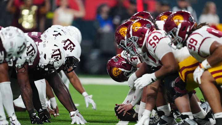 Dec 27, 2024; Las Vegas, NV, USA; Helmets at the line fo scrimmage as DUPLICATE***Southern California Trojans long snapper Hank Pepper (31) snaps the ball against the Texas A&M Aggies at Allegiant Stadium. 