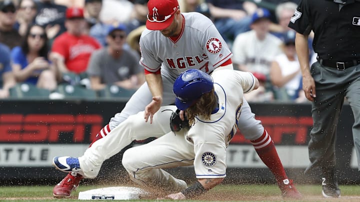 Angels third baseman Zack Cozart (7) tags out Seattle Mariners left fielder Ben Gamel (16) to end the fifth inning at Safeco Field on May 6, 2018.