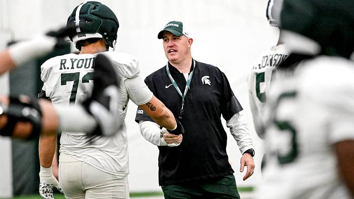 Michigan State's head coach Pat Fitzgerald, right, talks with Rustin Young during spring football practice on Tuesday, April 14, 2026, in East Lansing. Michigan State's head coach Pat Fitzgerald, right, talks with Rustin Young during spring football practice on Tuesday, April 14, 2026, in East Lansing.
