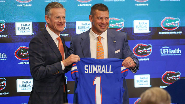 UF Athletic Director Scott Stricklin and new UF head football coach Jon Sumrall pose with a jersey at a press conference James W. “Bill” Heavener Football Training Center in Gainesville, FL on Monday, December 1, 2025. [Alan Youngblood/Gainesville Sun]