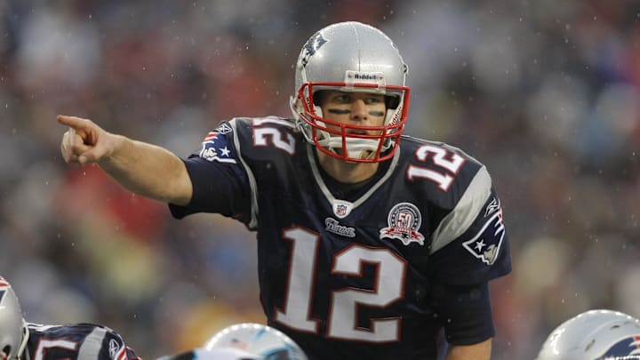 Dec 13, 2009; Foxborough, MA, USA; New England Patriots quarterback Tom Brady (12) signals before the snap against the Carolina Panthers during the second quarter at Gillette Stadium. Mandatory Credit: David Butler II-Imagn Images