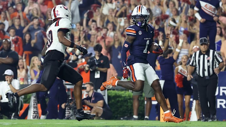Sep 6, 2025; Auburn, Alabama, USA; Auburn Tigers wide receiver Eric Singleton Jr. (1) beats out Ball State Cardinals defensive back Jahmad Harmon (10) and scores a touchdown during the fourth quarter at Jordan-Hare Stadium. Mandatory Credit: John Reed-Imagn Images Sep 6, 2025; Auburn, Alabama, USA; Auburn Tigers wide receiver Eric Singleton Jr. (1) beats out Ball State Cardinals defensive back Jahmad Harmon (10) and scores a touchdown during the fourth quarter at Jordan-Hare Stadium. Mandatory Credit: John Reed-Imagn Images