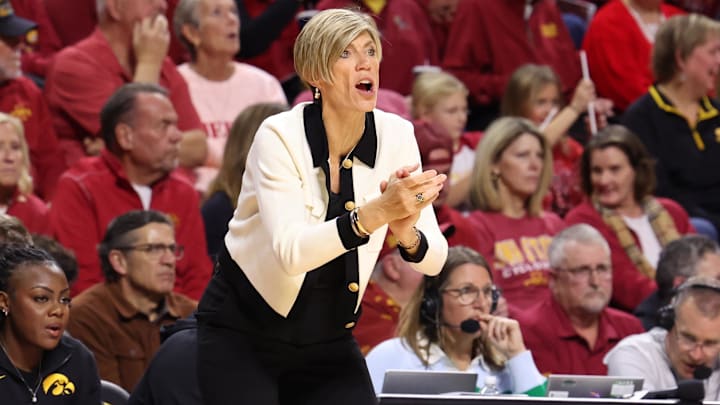 Dec 10, 2025; Ames, Iowa, USA; Iowa Hawkeyes coach Jan Jensen watches her team play the Iowa State Cyclones during the first half at James H. Hilton Coliseum. Mandatory Credit: Reese Strickland-Imagn Images