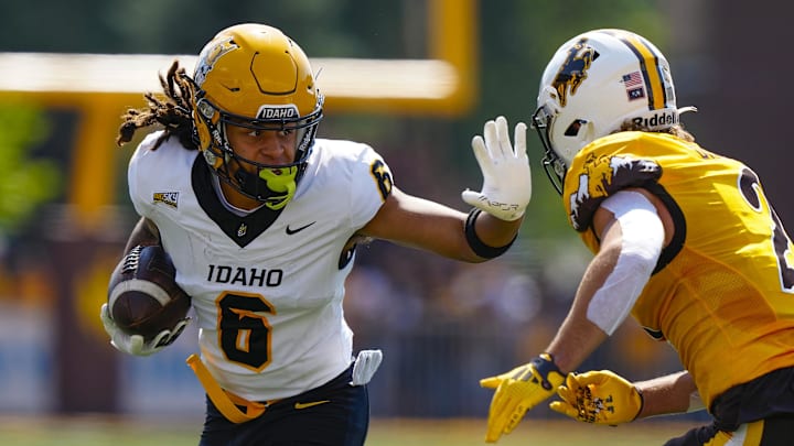 Sep 7, 2024; Laramie, Wyoming, USA; Idaho Vandals wide receiver Jordan Dwyer (6) stiff arms Wyoming Cowboys nose guard Wrook Brown (2) during the first quarter at Jonah Field at War Memorial Stadium. Mandatory Credit: Troy Babbitt-Imagn Images Sep 7, 2024; Laramie, Wyoming, USA; Idaho Vandals wide receiver Jordan Dwyer (6) stiff arms Wyoming Cowboys nose guard Wrook Brown (2) during the first quarter at Jonah Field at War Memorial Stadium. Mandatory Credit: Troy Babbitt-Imagn Images
