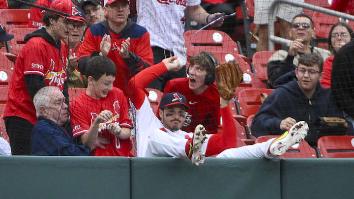 May 25, 2025; St. Louis, Missouri, USA;  St. Louis Cardinals third baseman Nolan Arenado (28) falls in to the crowd after catching a foul ball hit by Arizona Diamondbacks second baseman Ketel Marte (not pictured) during the ninth inning at Busch Stadium. Mandatory Credit: Jeff Curry-Imagn Images