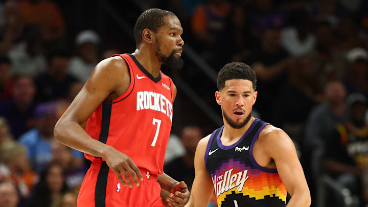 Apr 7, 2026; Phoenix, Arizona, USA; Phoenix Suns guard Devin Booker (1) against Houston Rockets forward Kevin Durant (7) in the second half at Mortgage Matchup Center. Mandatory Credit: Mark J. Rebilas-Imagn Images
