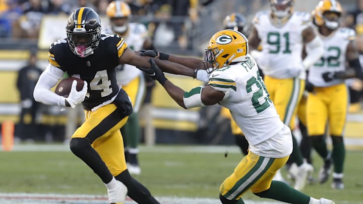 Nov 12, 2023; Pittsburgh, Pennsylvania, USA;  Pittsburgh Steelers wide receiver George Pickens (14) runs after a catch against Green Bay Packers safety Rudy Ford (20) during the fourth quarter at Acrisure Stadium. Pittsburgh won 23-19. Mandatory Credit: Charles LeClaire-USA TODAY Sports