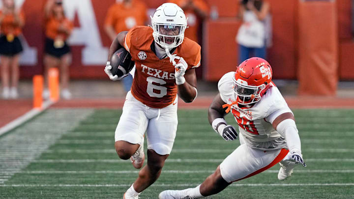 Sep 20, 2025; Austin, Texas, USA; Texas Longhorns running back Christian Clark (6) runs for yards past Sam Houston Bearkats defensive lineman Darius Jackson (90) during the first half at Darrell K Royal-Texas Memorial Stadium. Mandatory Credit: Scott Wachter-Imagn Images