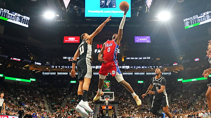 Apr 6, 2026; San Antonio, Texas, USA; Philadelphia 76ers guard Tyrese Maxey (0) drives to the basket against San Antonio Spurs forward Carter Bryant (11) and guard Stephon Castle (5) during the second half at Frost Bank Center. Mandatory Credit: Scott Wachter-Imagn Images Apr 6, 2026; San Antonio, Texas, USA; Philadelphia 76ers guard Tyrese Maxey (0) drives to the basket against San Antonio Spurs forward Carter Bryant (11) and guard Stephon Castle (5) during the second half at Frost Bank Center. Mandatory Credit: Scott Wachter-Imagn Images