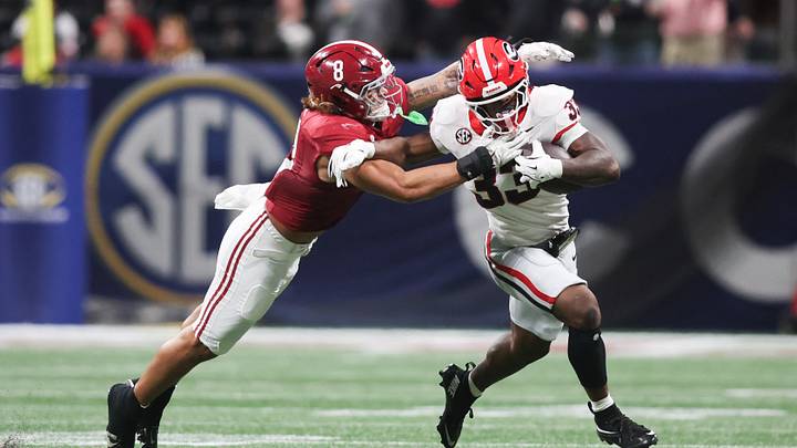 Dec 6, 2025; Atlanta, GA, USA; Georgia Bulldogs running back Chauncey Bowens (33) rushes as Alabama Crimson Tide linebacker Justin Hill (8) tackles during the second quarter during the 2025 SEC Championship game at Mercedes-Benz Stadium. Mandatory Credit: Brett Davis-Imagn Images Dec 6, 2025; Atlanta, GA, USA; Georgia Bulldogs running back Chauncey Bowens (33) rushes as Alabama Crimson Tide linebacker Justin Hill (8) tackles during the second quarter during the 2025 SEC Championship game at Mercedes-Benz Stadium. Mandatory Credit: Brett Davis-Imagn Images