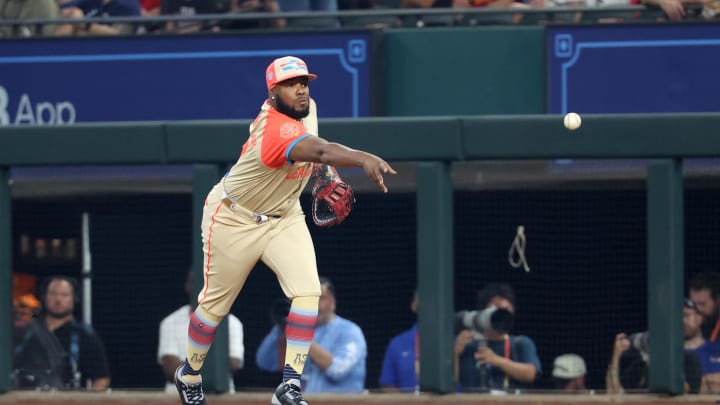 Jul 16, 2024; Arlington, Texas, USA; American League first baseman Vladimir Guerrero Jr. of the Toronto Blue Jays (27) throws for an out in the first inning against the National League during the 2024 MLB All-Star game at Globe Life Field. 