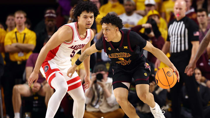 Jan 31, 2026; Tempe, Arizona, USA; Arizona State Sun Devils guard Bryce Ford (4) controls the ball against Arizona Wildcats guard Brayden Burries (5) in the first half at Desert Financial Arena. Mandatory Credit: Mark J. Rebilas-Imagn Images