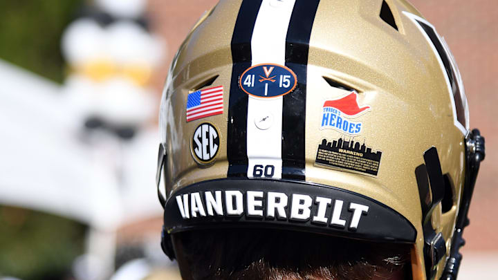 Nov 19, 2022; Nashville, Tennessee, USA; View of stickers on the helmet of Vanderbilt Commodores offensive lineman Duncan MacDonald (60) to honor the Virginia players who died in a shooting at FirstBank Stadium. Mandatory Credit: Christopher Hanewinckel-Imagn Images