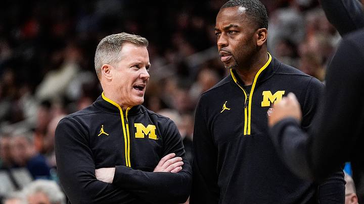 Michigan head coach Dusty May talks to assistant coach Mike Boynton Jr. during the second half of the Sweet 16 round of NCAA tournament at State Farm Arena in Atlanta, Ga. on Friday, March 28, 2025.