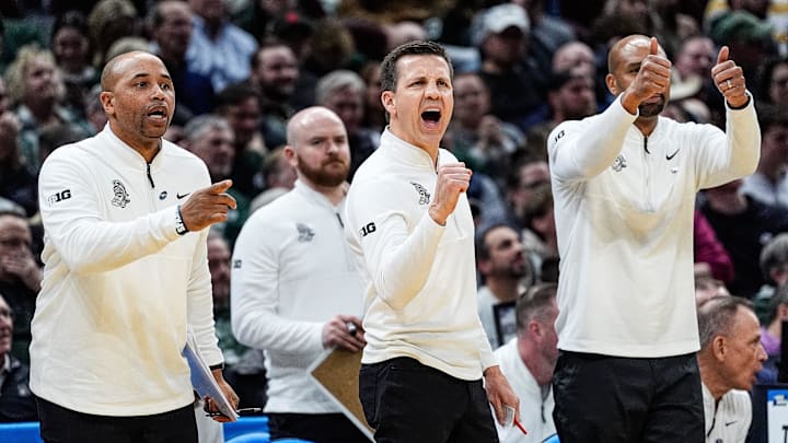 From left, Michigan State assistant coaches Thomas Kelley, Jon Borovich, and Saddi Washington celebrate a play against Bryant during the second half of the First Round of NCAA Tournament at Rocket Arena in Cleveland, Ohio on Friday, March 21, 2025.