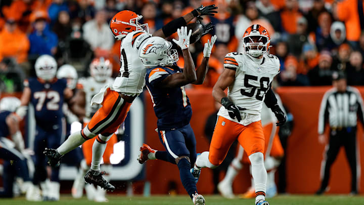 Dec 2, 2024; Denver, Colorado, USA; Denver Broncos wide receiver Marvin Mims Jr. (19) pulls in a pass against Cleveland Browns cornerback Denzel Ward (21) and linebacker Jordan Hicks (58) in the third quarter at Empower Field at Mile High. 