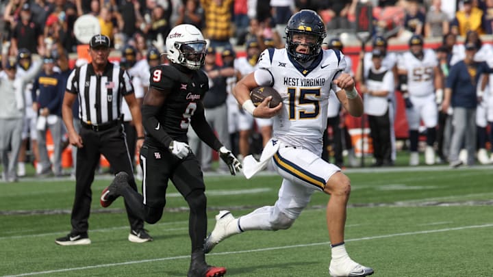 Nov 1, 2025; Houston, Texas, USA; West Virginia Mountaineers quarterback Scotty Fox Jr. (15) rushes for a touchdown against tHouston Cougars linebacker Corey Platt Jr. (9)  in the second half at TDECU Stadium. Mandatory Credit: Thomas Shea-Imagn Images