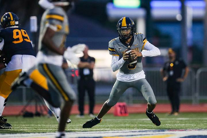 American Heritage Patriots quarterback Dia Bell (3) scrambles in the backfield against the Naples Golden Eagles.
