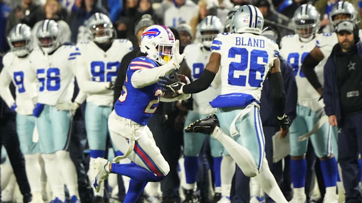 Dec 17, 2023; Orchard Park, New York, USA; Buffalo Bills running back Ty Johnson (26) runs the ball pressured by Dallas Cowboys cornerback DaRon Bland (26).