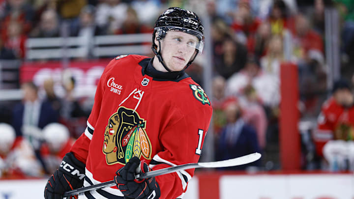 Nov 18, 2025; Chicago, Illinois, USA; Chicago Blackhawks center Oliver Moore (11) looks on during the second period of an NHL game against the Calgary Flames at United Center. Mandatory Credit: Kamil Krzaczynski-Imagn Images