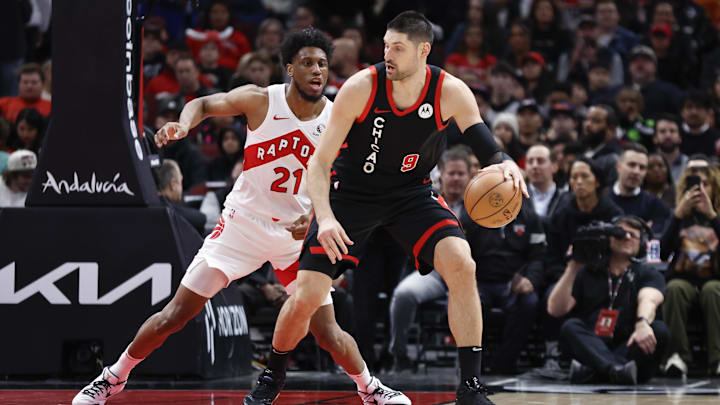 Jan 30, 2024; Chicago, Illinois, USA; Toronto Raptors forward Thaddeus Young (21) defends against Chicago Bulls center Nikola Vucevic (9) during the first half at United Center. Mandatory Credit: Kamil Krzaczynski-Imagn Images